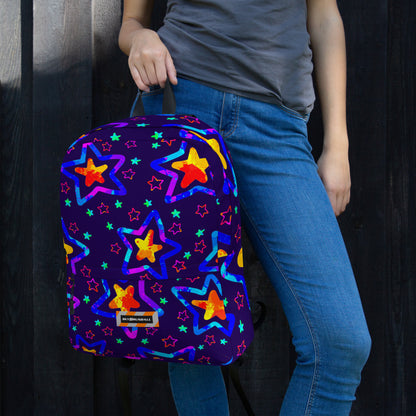 Person holding a colorful star-patterned backpack against a dark background