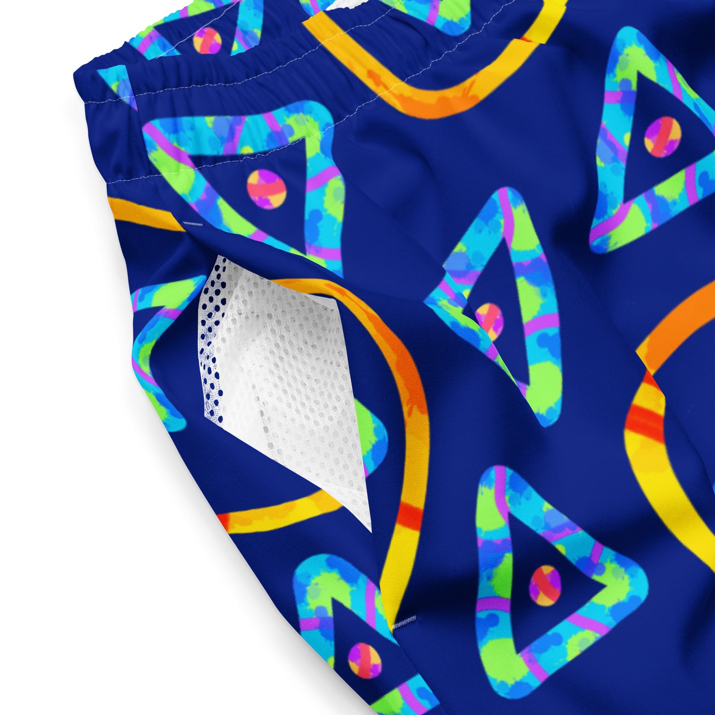 Colorful geometric patterned swim trunks on a blue background