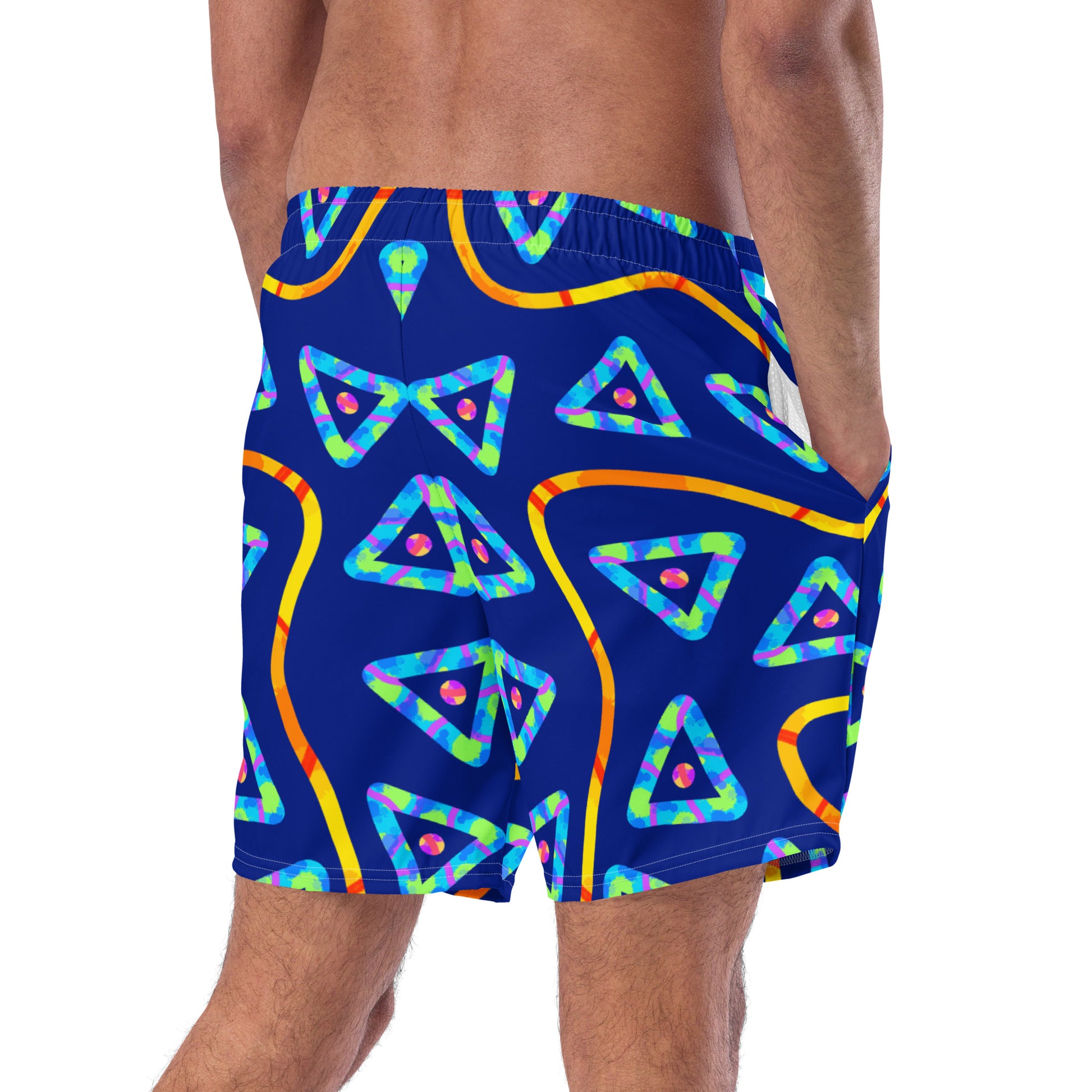 Blue swim shorts with colorful geometric pattern worn by a person on a white background