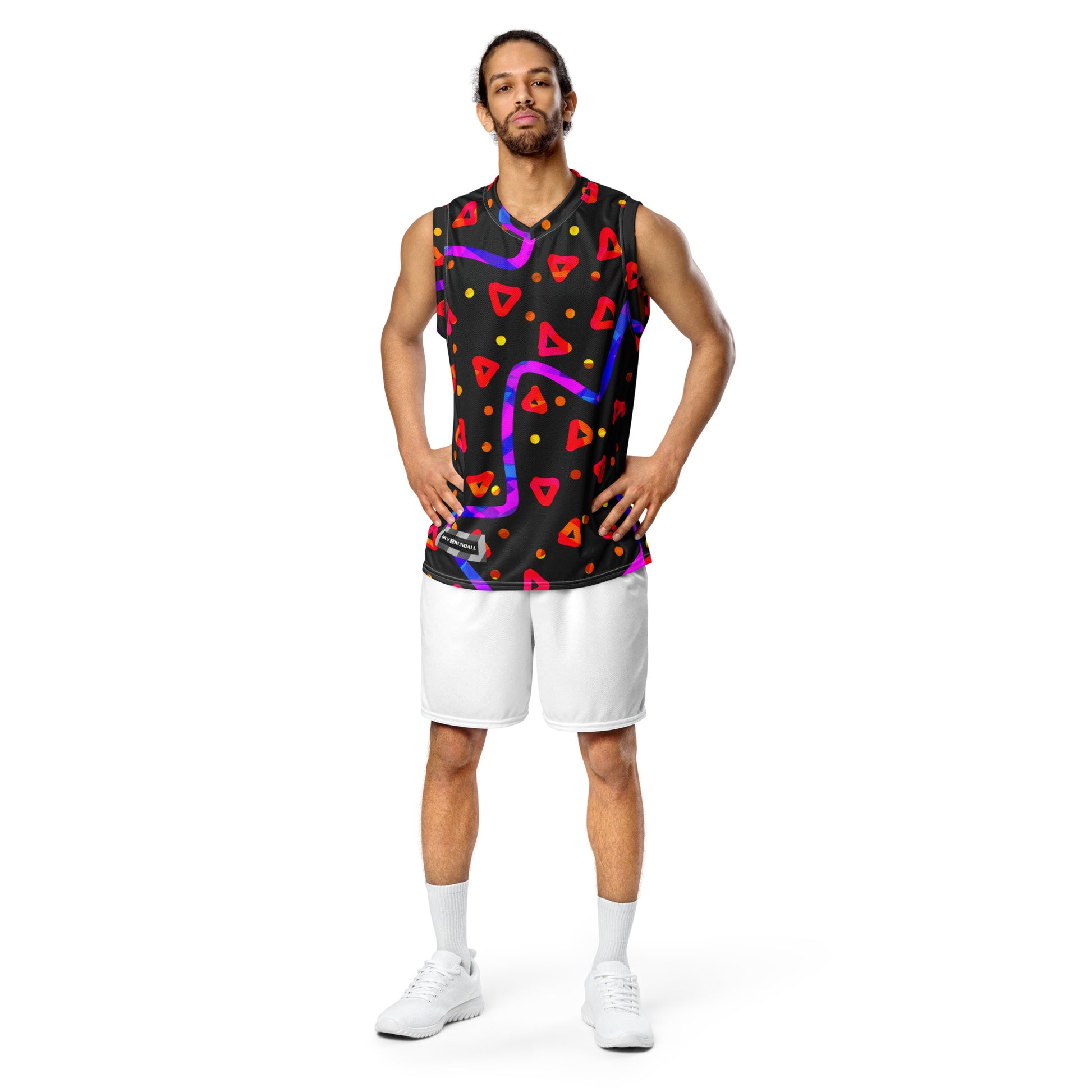 Man wearing a sleeveless shirt with colorful geometric patterns on a white background