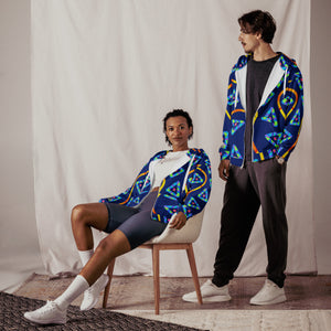 Two people wearing colorful patterned jackets in a studio setting.
