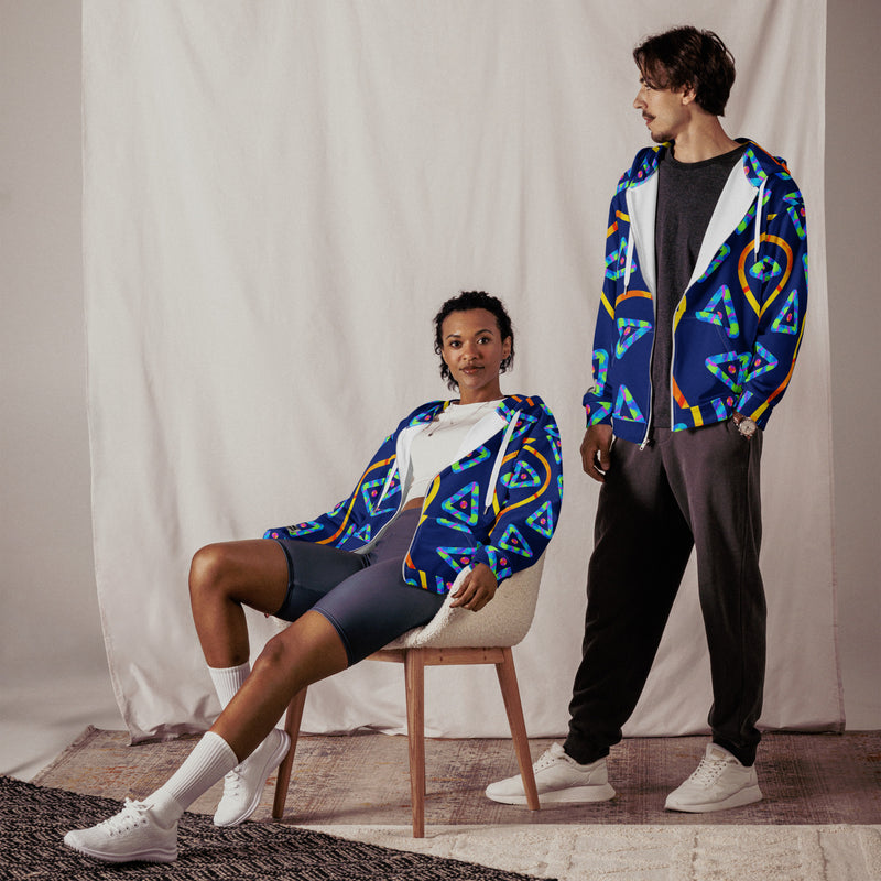 Two people wearing colorful patterned jackets in a studio setting.