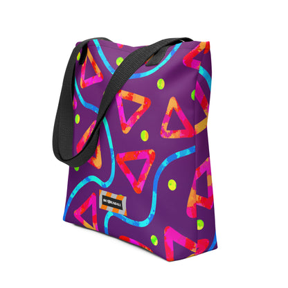 Colorful geometric-patterned bag with a black strap on a white background