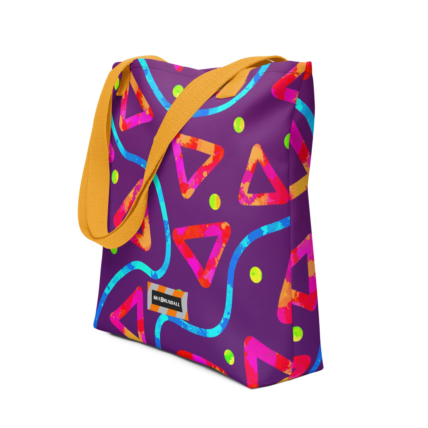 Colorful geometric-patterned bag with a yellow strap on a white background