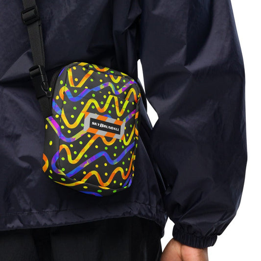 Back view of person wearing a navy blue jacket, carrying a crossbody bag printed with "Thunder Burst" from the Dream Wave Festival collection series, and featuring the Sky Brundall logo.