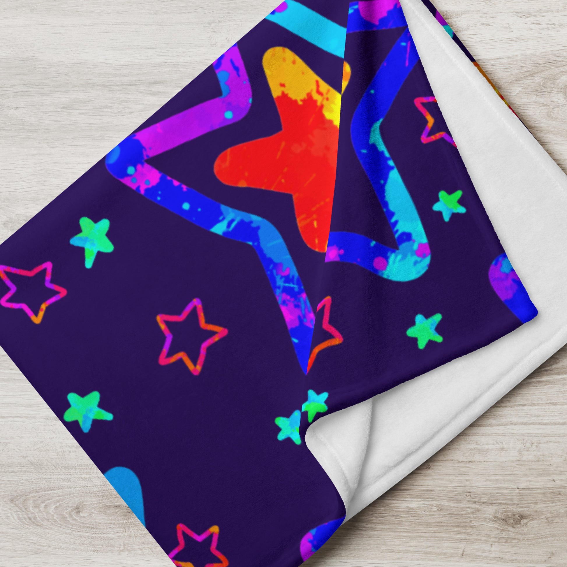 Colorful star pattern on a purple fabric with a wooden surface background