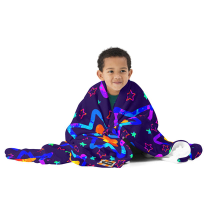 Child wrapped in a colorful blanket with star patterns on a white background