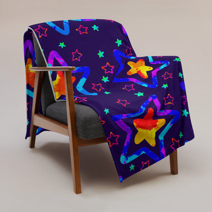 Colorful star-patterned blanket draped over a chair on a plain background