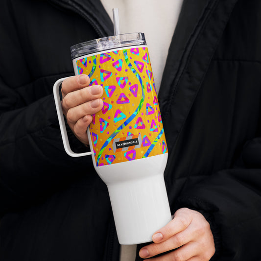 Person holding a colorful insulated tumbler with geometric pattern